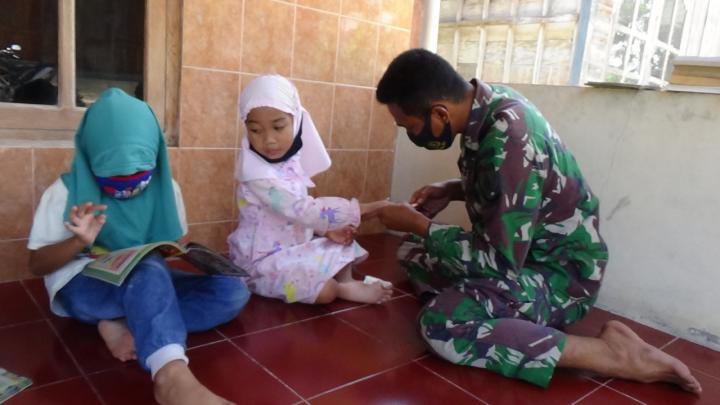 Jalin Komunikasi, Anggota Satgas TMMD Bojonegoro Potongi Kuku Anak-Anak